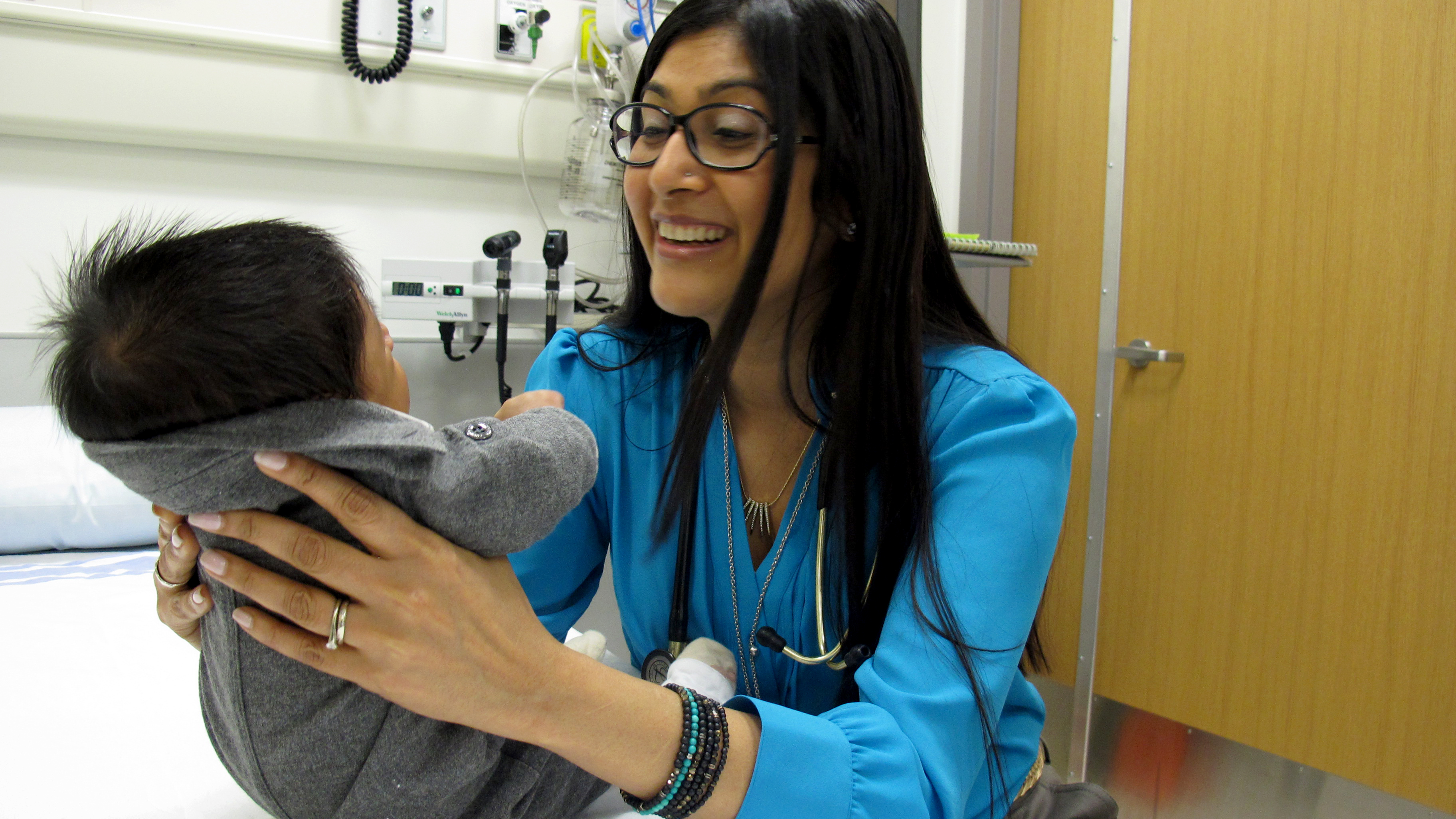 Dr. Samina Ali examines a young patient