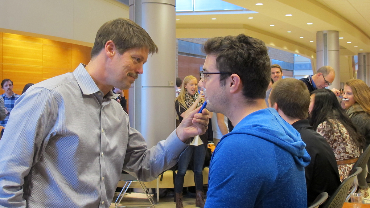 Dr. John Lewis, a men's cancer researcher, shaves a medical student during the Movember 2014 shave off 