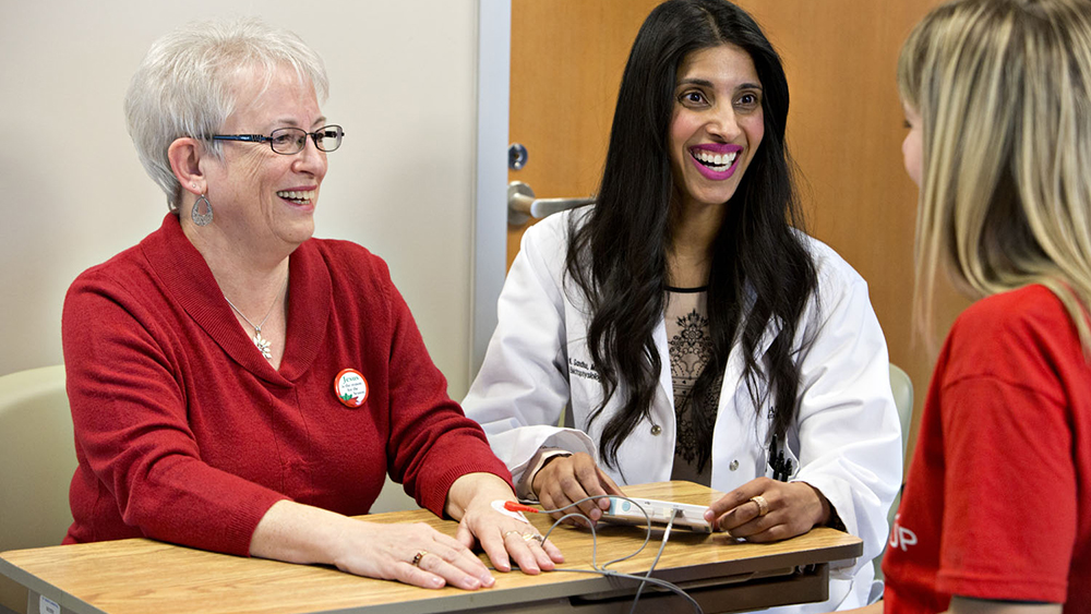 Retiree Dona Taverner, left, gets a heart-health check-up from Dr. Roopinder Sandhu and research co-ordinator Janis Baarda as part of the PIAAF-Pharmacy Study which seeks to identify Atrial Fibrillation (AF) in seniors as a strategy to prevent strokes. Photo credit: Jason Franson