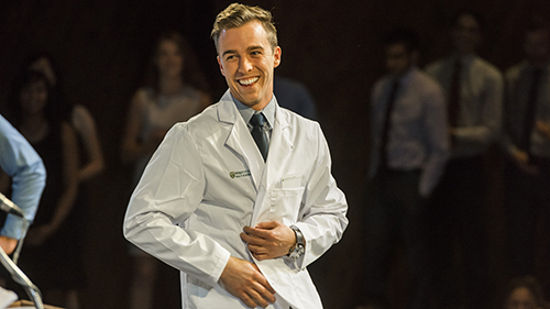 Dr. D. Douglas Miller shakes the hand of an MD student at the 2014 White Coat Ceremony