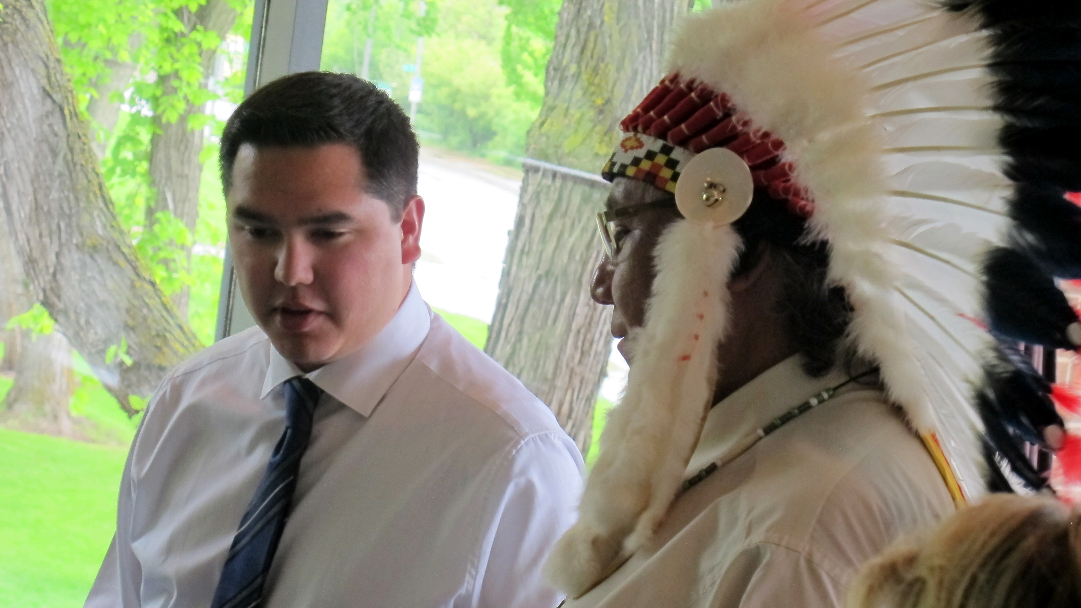 Shey Eagle Bear and Elder Leonard Saddleback during the eagle feather ceremony